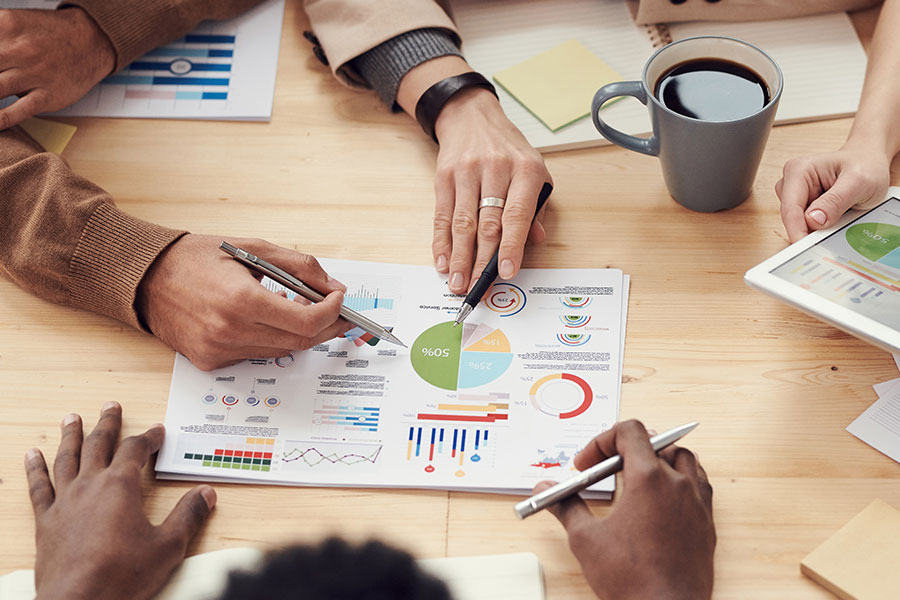 People analyzing charts and graphs during a business meeting.